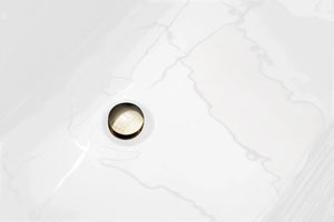 Drain detail of Diamond bathtub. Drain polished gold.